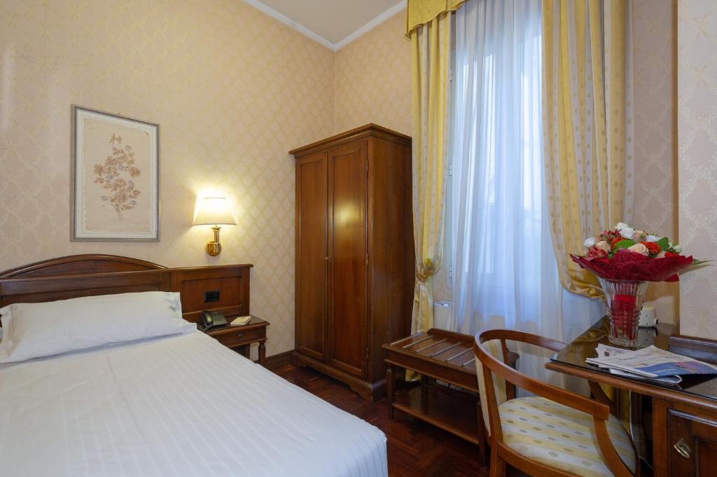 Postel nebo postele na pokoji v ubytování Hotel Boccaccio