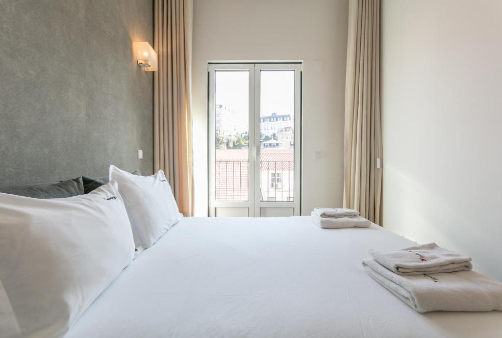 Postel nebo postele na pokoji v ubytování FLH Restauradores Modern Apartment