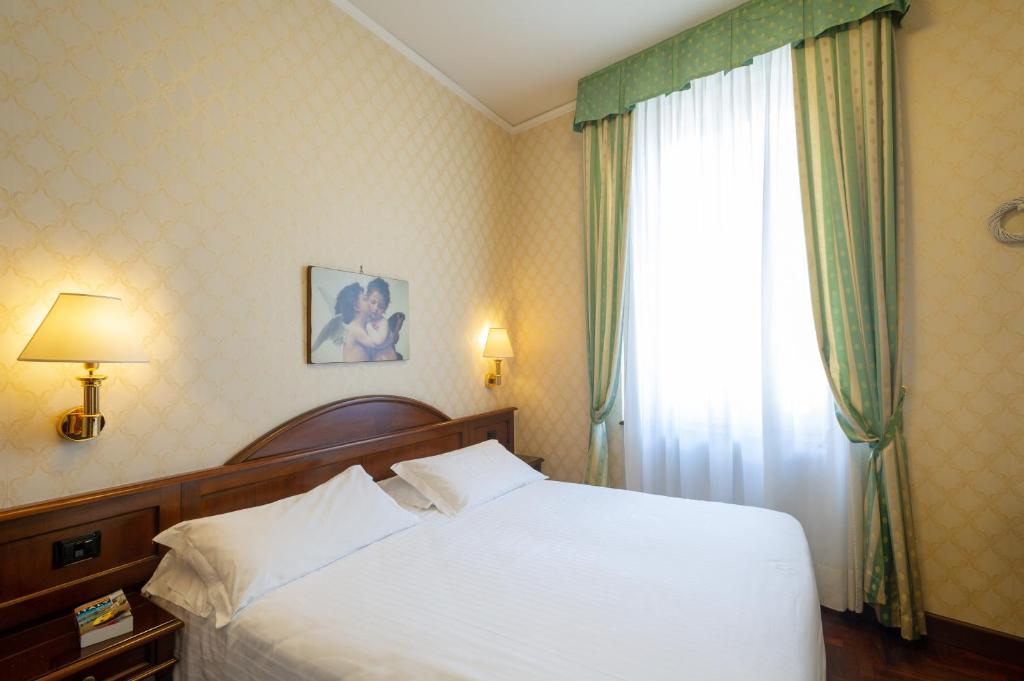 Postel nebo postele na pokoji v ubytování Hotel Boccaccio