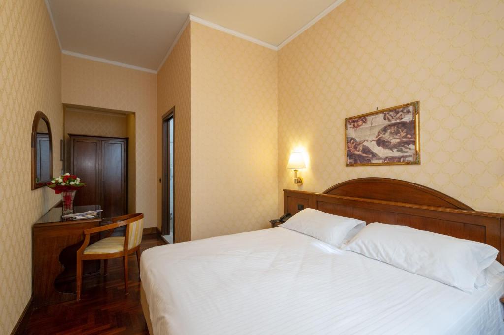 Postel nebo postele na pokoji v ubytování Hotel Boccaccio