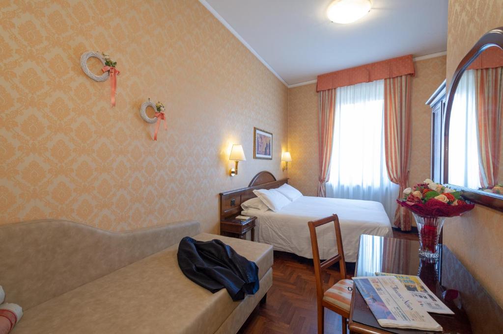 Postel nebo postele na pokoji v ubytování Hotel Boccaccio
