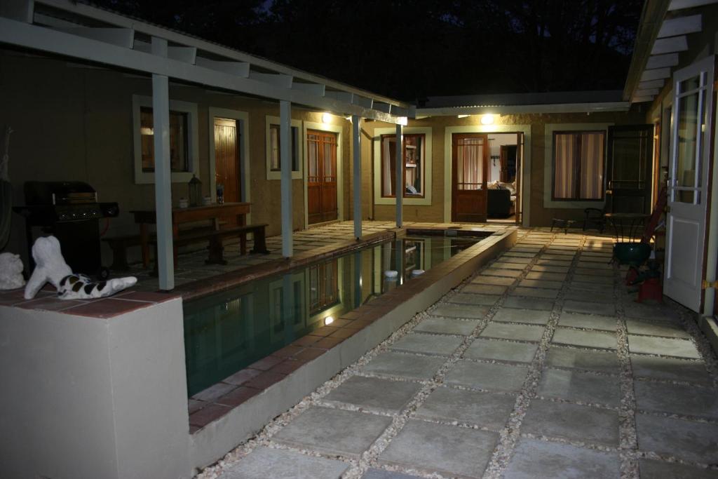 a house with a swimming pool at night at And the cow jumped over the moon... in Nieu-Bethesda