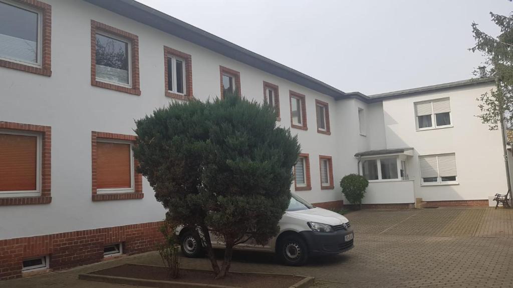 a car parked in a parking lot in front of a house at ABC-Monteurzimmer in Magdeburg