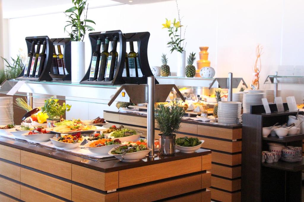 a buffet with many plates of food on display at Hotel Neptun in Warnemünde