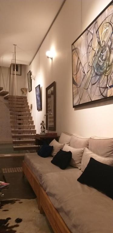 a large bed in a room with a painting on the wall at Dar d'Art in Marrakesh