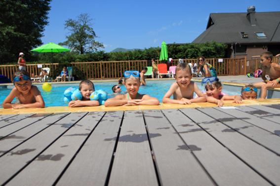 a group of babies laying in a swimming pool at Hôtel Domaine du Lac Chambon in Murol