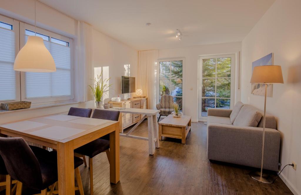 a living room with a table and a couch at BUTZ home in Scharbeutz