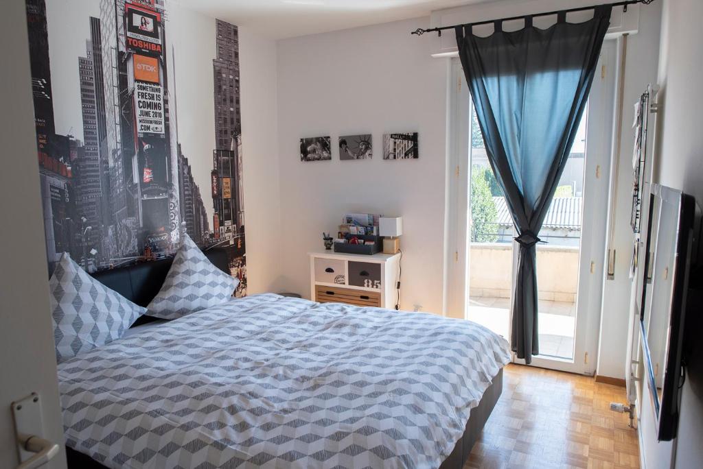 a bedroom with a bed and a large window at Locarno - Casa Pioda in Locarno