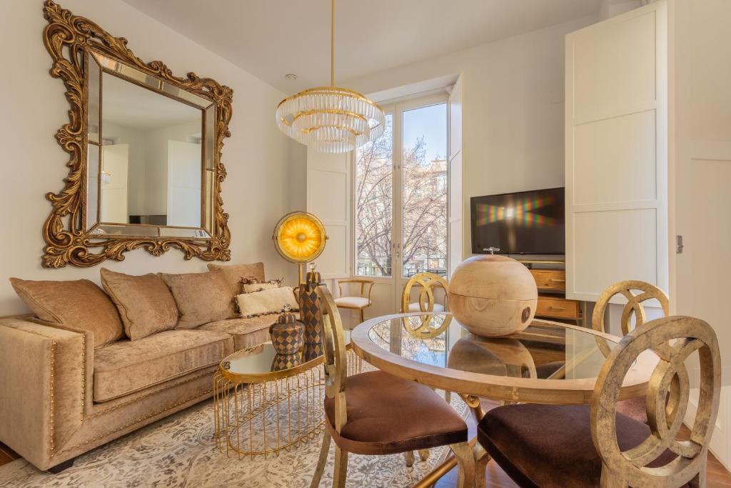 a living room with a couch and a table with a mirror at Bib Rambla Luxury Apartments in Granada