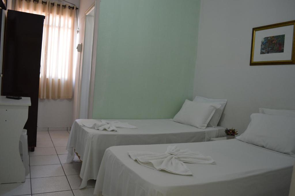 Postel nebo postele na pokoji v ubytování Hotel Confort Maringá