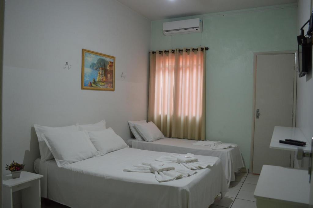 Postel nebo postele na pokoji v ubytování Hotel Confort Maringá