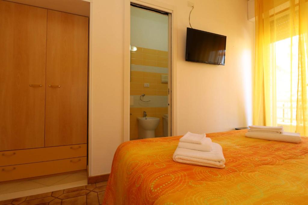 Postel nebo postele na pokoji v ubytování B&B Spiaggia di Ponente