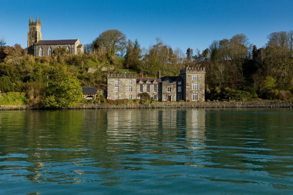 an old building on the shore of a body of water at The Castle in Castlehaven