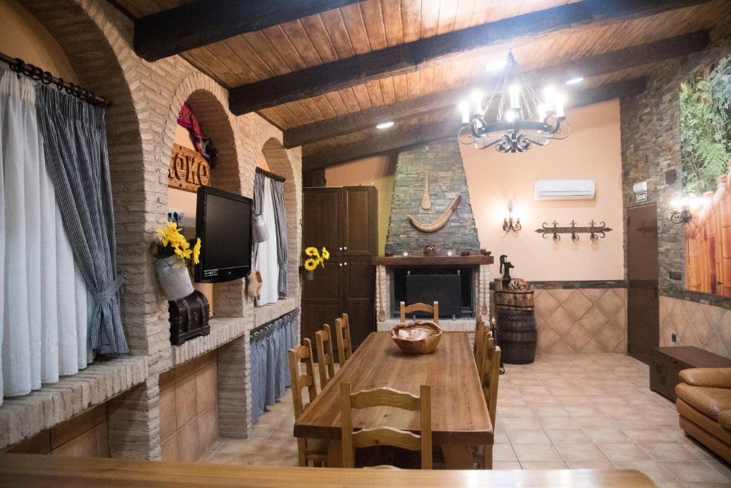 a dining room with a table and a fireplace at Aranaz Bardenas in Cadreita