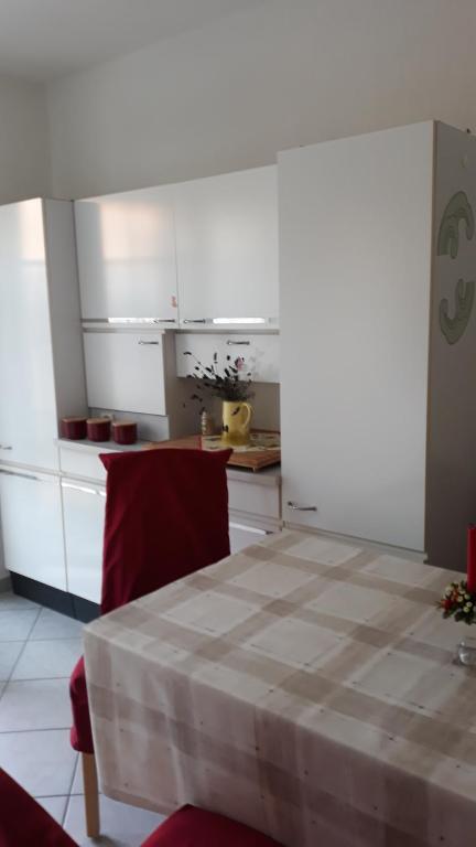 a kitchen with a table and a kitchen with white cabinets at 5 Gartenstraße in Angermünde