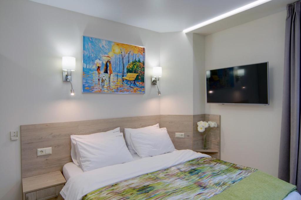 Postel nebo postele na pokoji v ubytování Arena Summit Apart Hotel