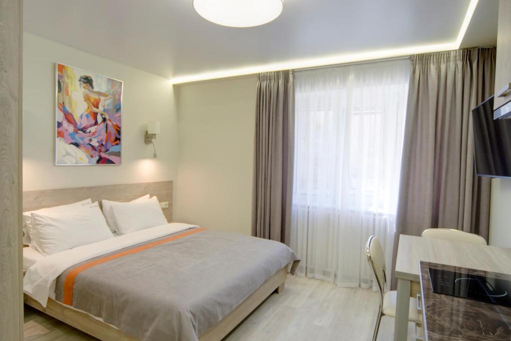 Postel nebo postele na pokoji v ubytování Arena Summit Apart Hotel