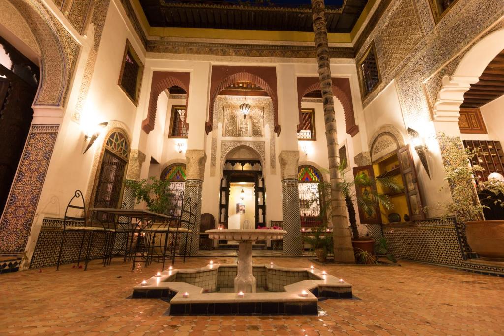 a church with a fountain in the middle of a building at Riad El Ma in Meknès