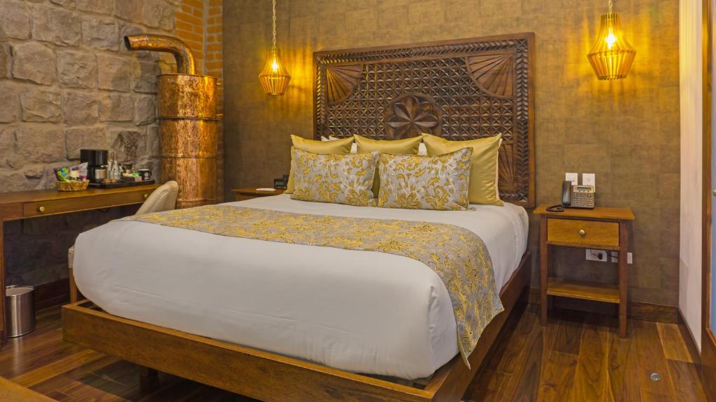 Postel nebo postele na pokoji v ubytování Hotel Otavalo