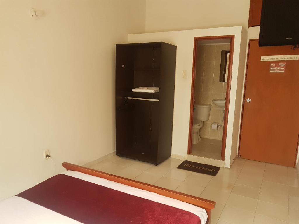 Postel nebo postele na pokoji v ubytování Hotel Don Juan Colonial