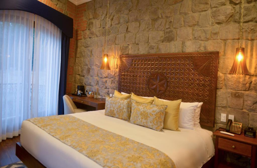 Postel nebo postele na pokoji v ubytování Hotel Otavalo