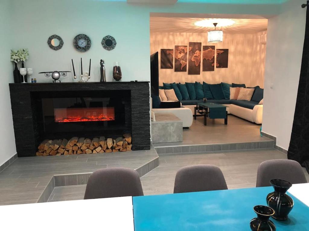 a living room with a fireplace and a couch at Pilot's Manor - Airport Villa in Velika Gorica