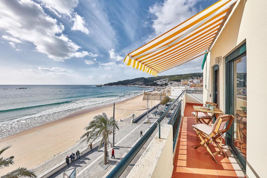 a balcony with a view of the beach at Música Penthouse 360º in Sesimbra