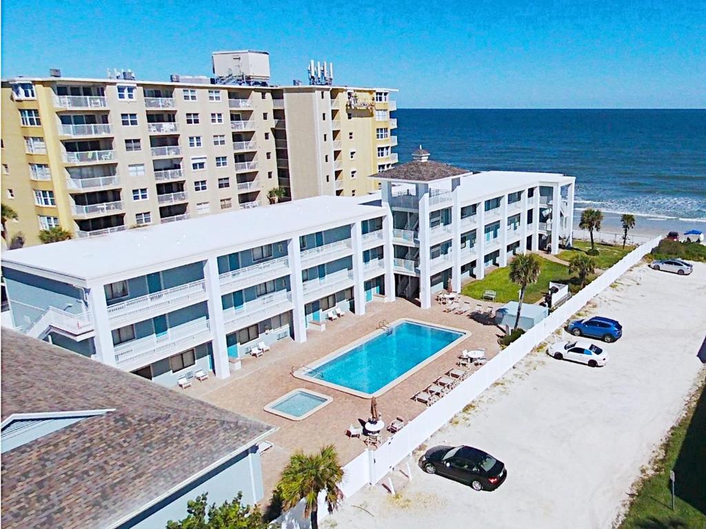 an aerial view of a hotel and the ocean at Coastal Waters in New Smyrna Beach