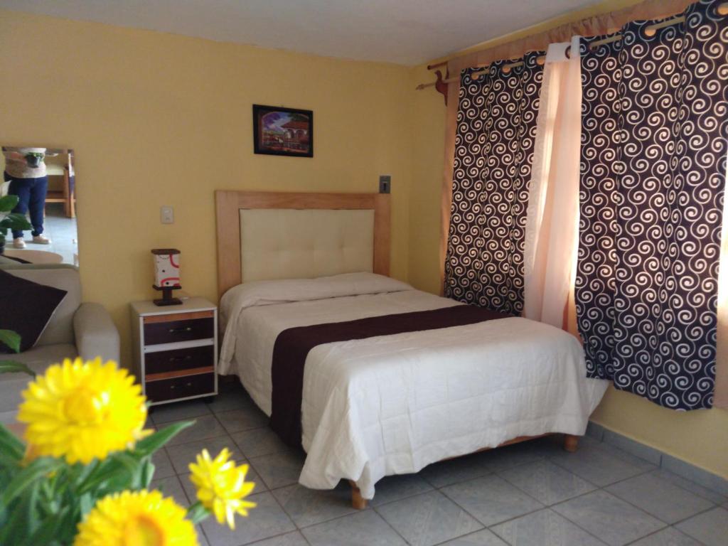 Letto o letti in una camera di El paraíso de Zacatlán DEPARTAMENTO con JARDÍN, 11 pax