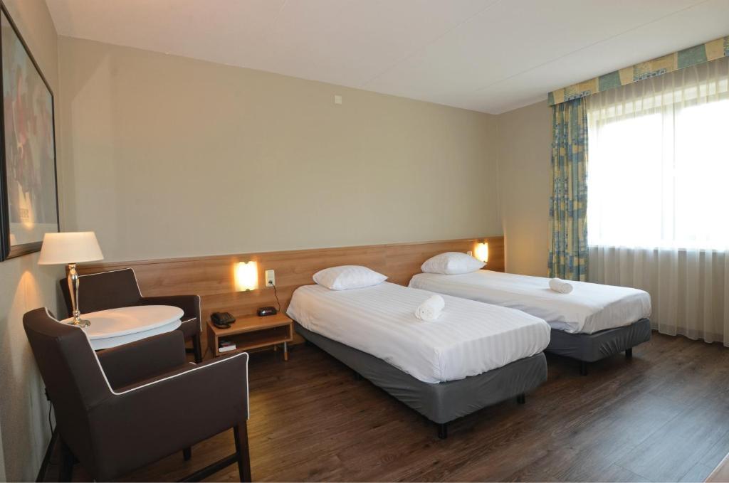 Postel nebo postele na pokoji v ubytování Fletcher Hotel Restaurant Heidehof