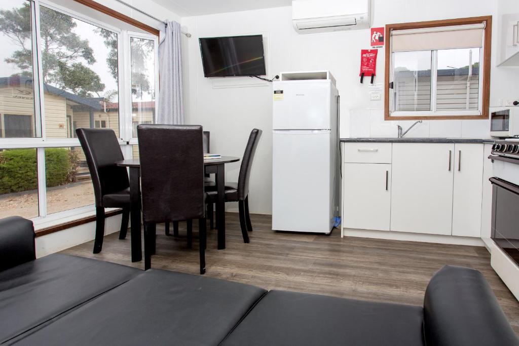 a kitchen and dining room with a table and chairs at Ingenia Holidays Torquay Australia in Torquay