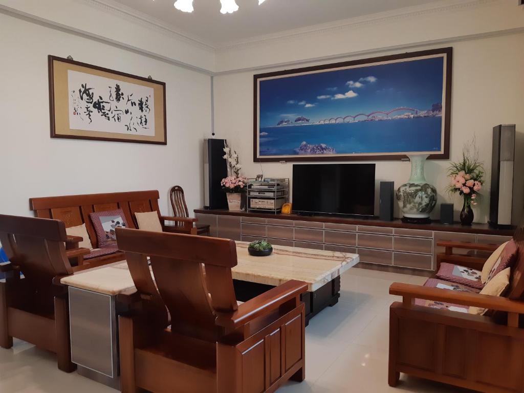 a living room with a large flat screen tv at Sea Bay in Taitung City