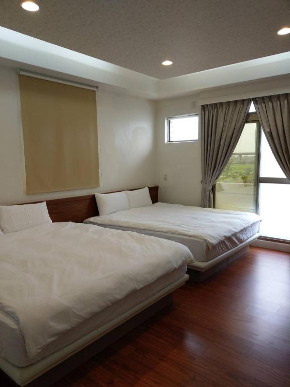 Postel nebo postele na pokoji v ubytování Malin 100 B&B Jiaoxi