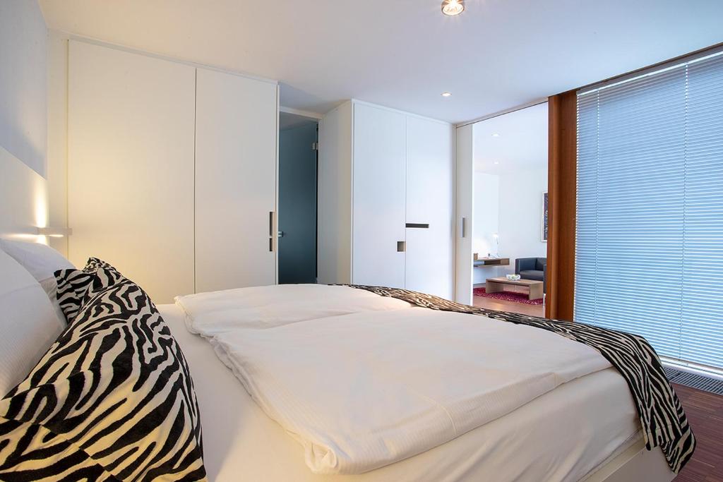 a bedroom with a large bed with zebra pillows at BECKER´S Hotel & Restaurant in Trier