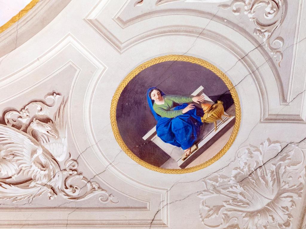 an overhead view of a woman sitting in a chair in a building at B&B Stupido Hotel in Florence