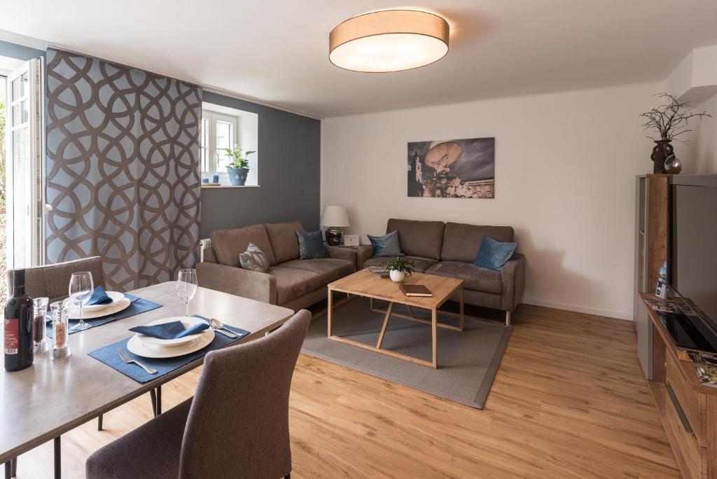 een woonkamer met een tafel en een bank bij Apartment Villa Leopoldskron in Salzburg