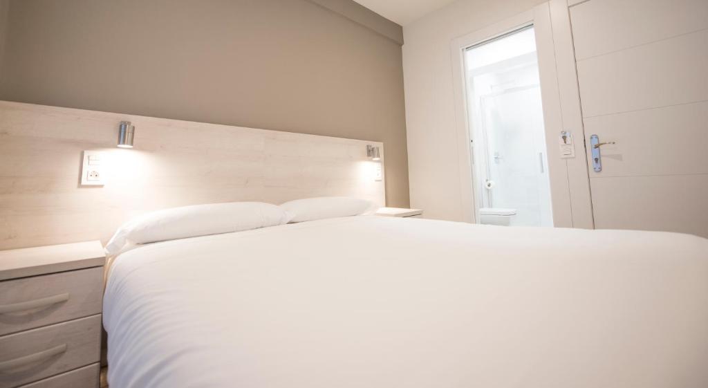 Posteľ alebo postele v izbe v ubytovaní Happy Hostal Carrales