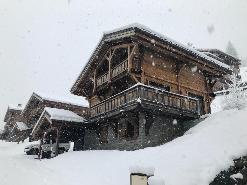 een groot houten huis met sneeuw erop bij Chalet Serin in Saint-Jean-dʼAulps