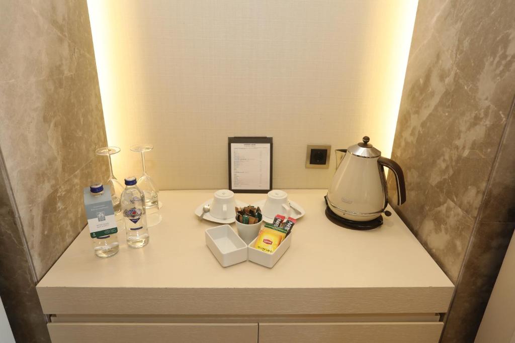 a table with a lamp and other items on it at Kemer Country Hotel İstanbul in Istanbul