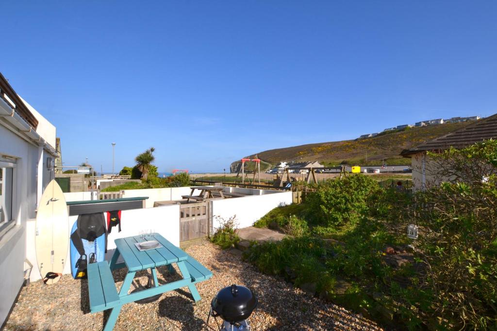 a blue table sitting on the side of a house at Beach View Apartments in Porthtowan