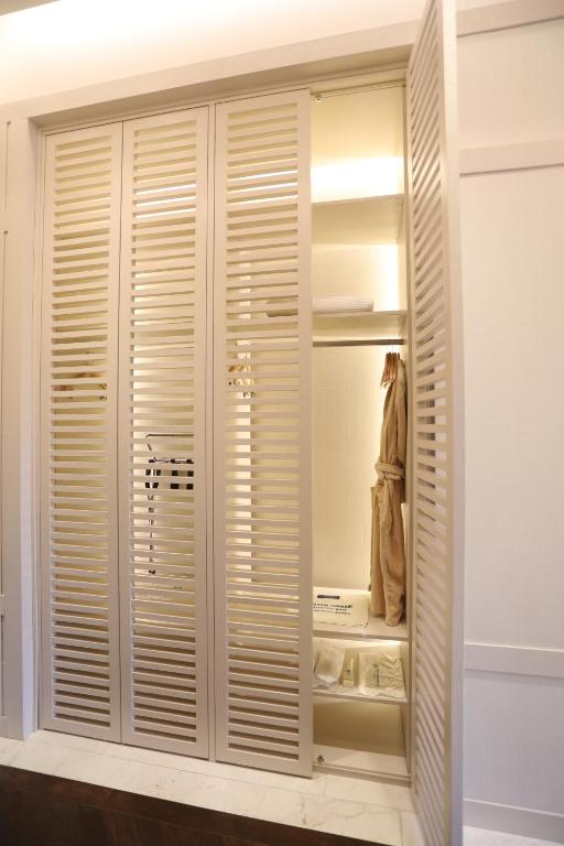 a closet with wooden shutters in a room at Kemer Country Hotel İstanbul in Istanbul