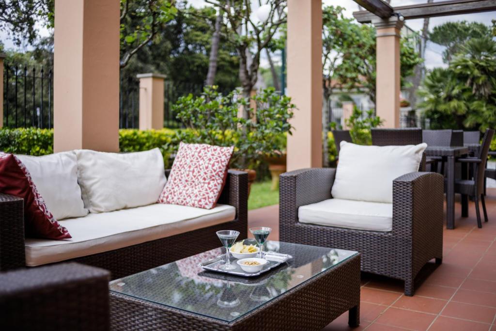 a patio with two chairs and a coffee table at Hotel Astor Victoria in Forte dei Marmi