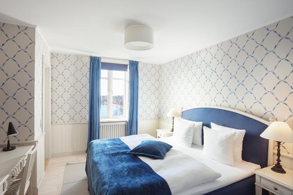 Postel nebo postele na pokoji v ubytování Hotel Bretagne