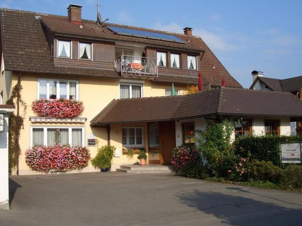 a large house with a balcony on top of it at Gästehaus Fischerhäusle in Mitten