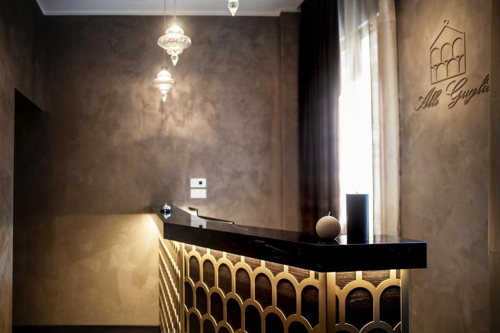 a room with a table and a chandelier at Alle Guglie Boutique Hotel in Venice