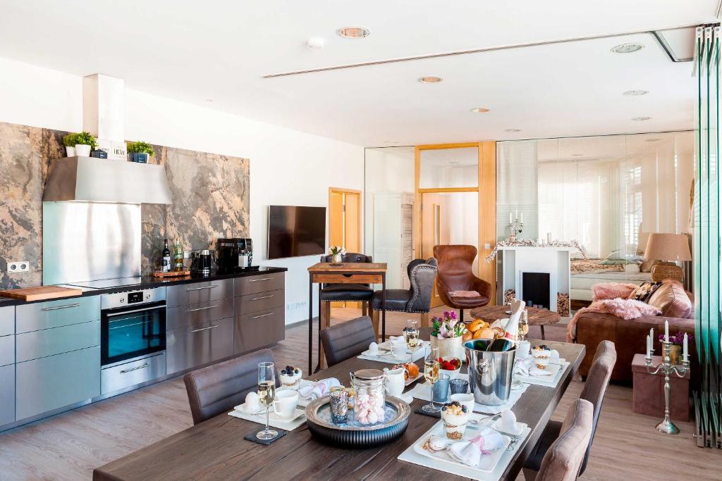 a kitchen and living room with a table with food on it at Ferienwohnung Relax Loft in Hallschlag