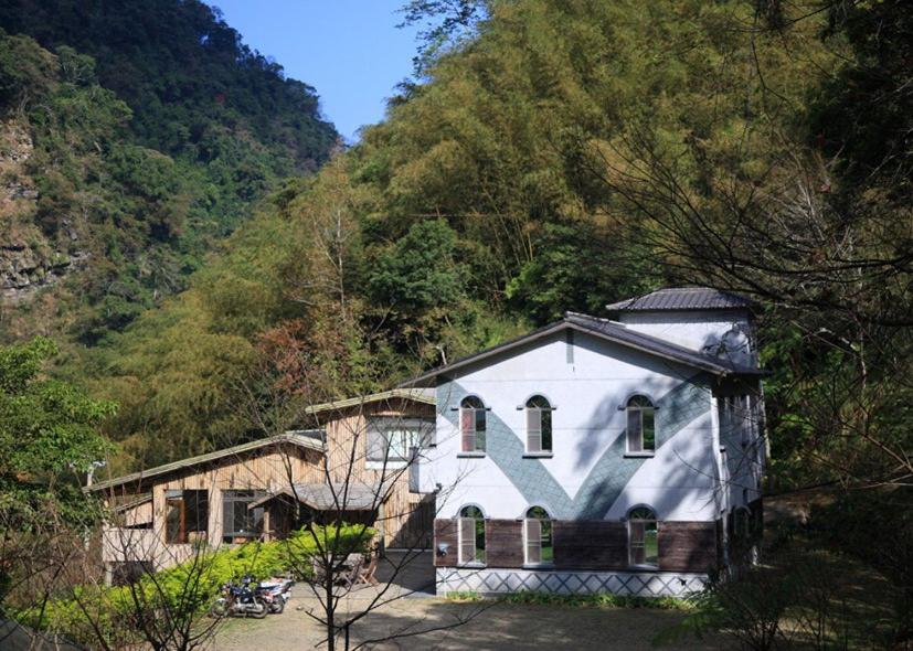 a white house in the middle of a mountain at Raisinay in Nanzhuang