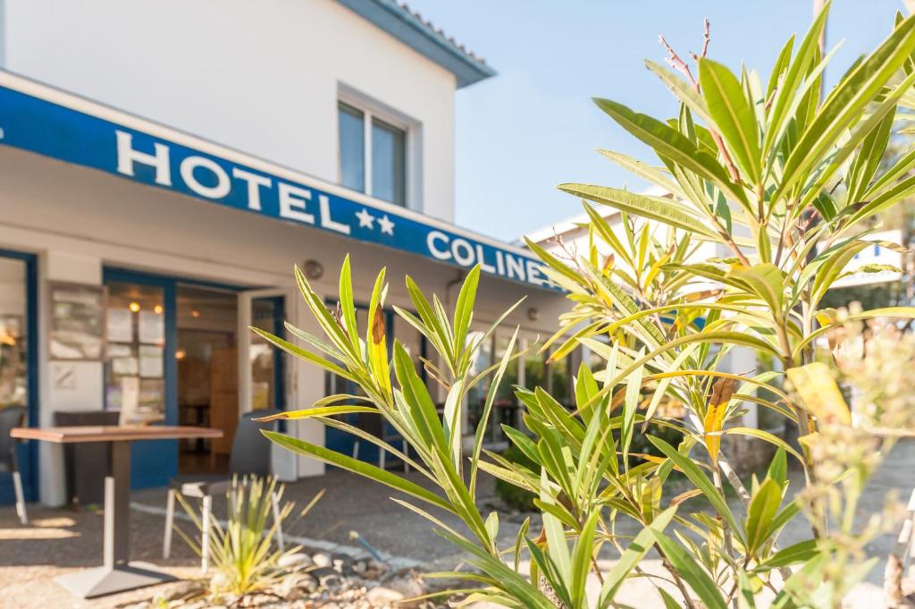 a sign in front of a hospital building at Hotel Colinette in Saint-Georges-de-Didonne