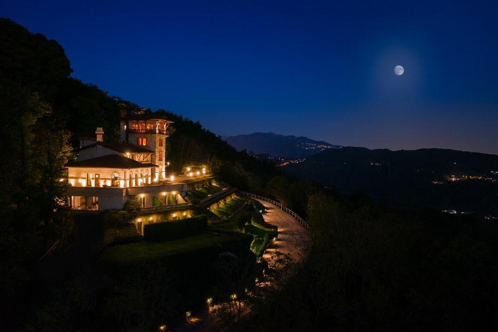 a building on the side of a hill at night at Tenuta De L'Annunziata - Natural Relais in Uggiate