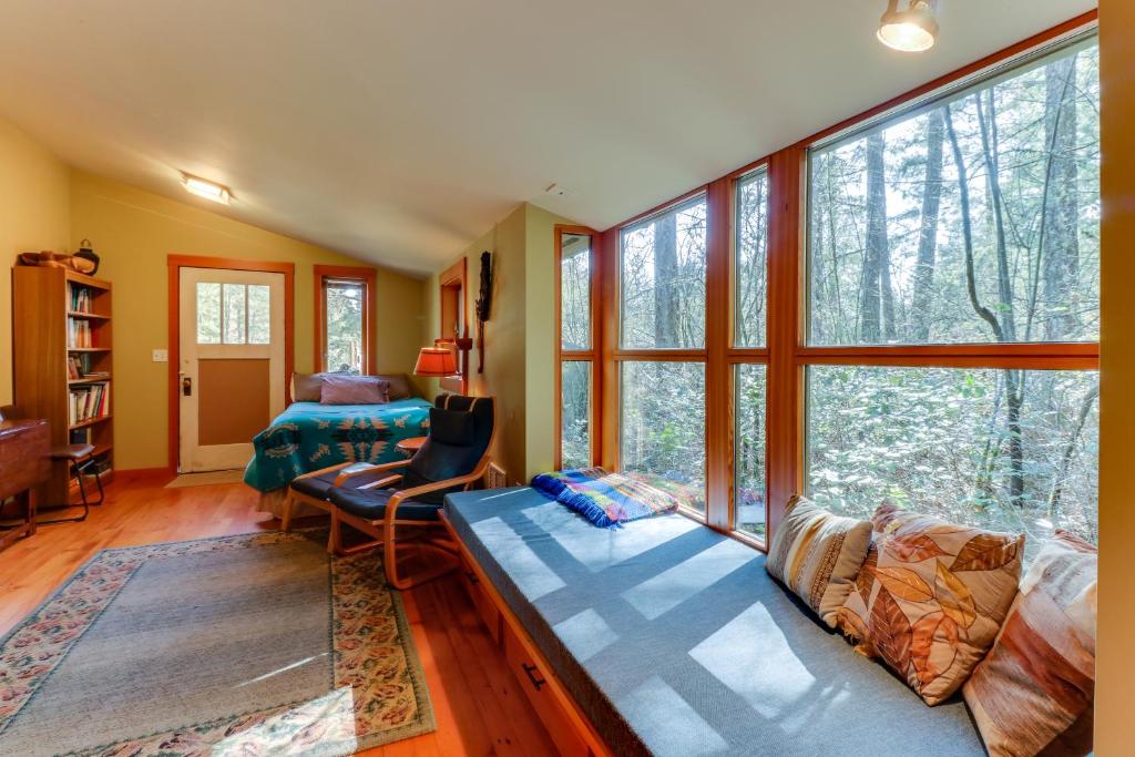 a living room with a couch and a large window at Island Artist Studio in Orcas
